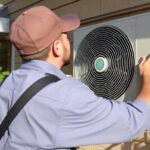 A professional air conditioning technician measuring and determining the proper AC size for a residential home in Indio, CA, considering factors like square footage, windows, and insulation for optimal efficiency.